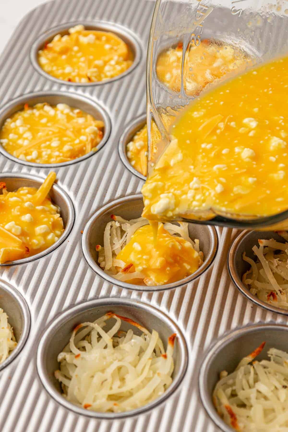 pouring egg filling over the hash browns