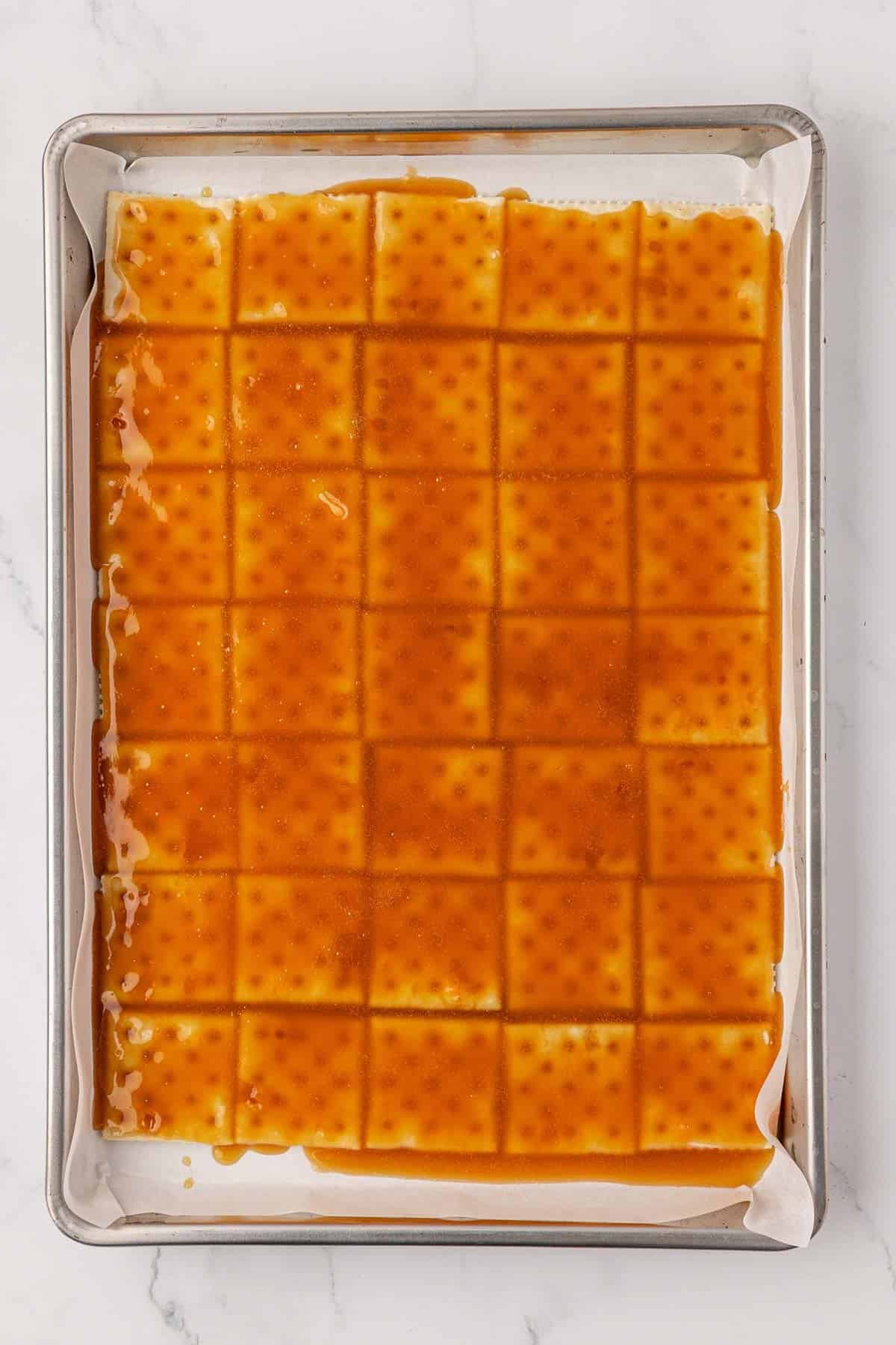 saltine crackers with toffee spread over them