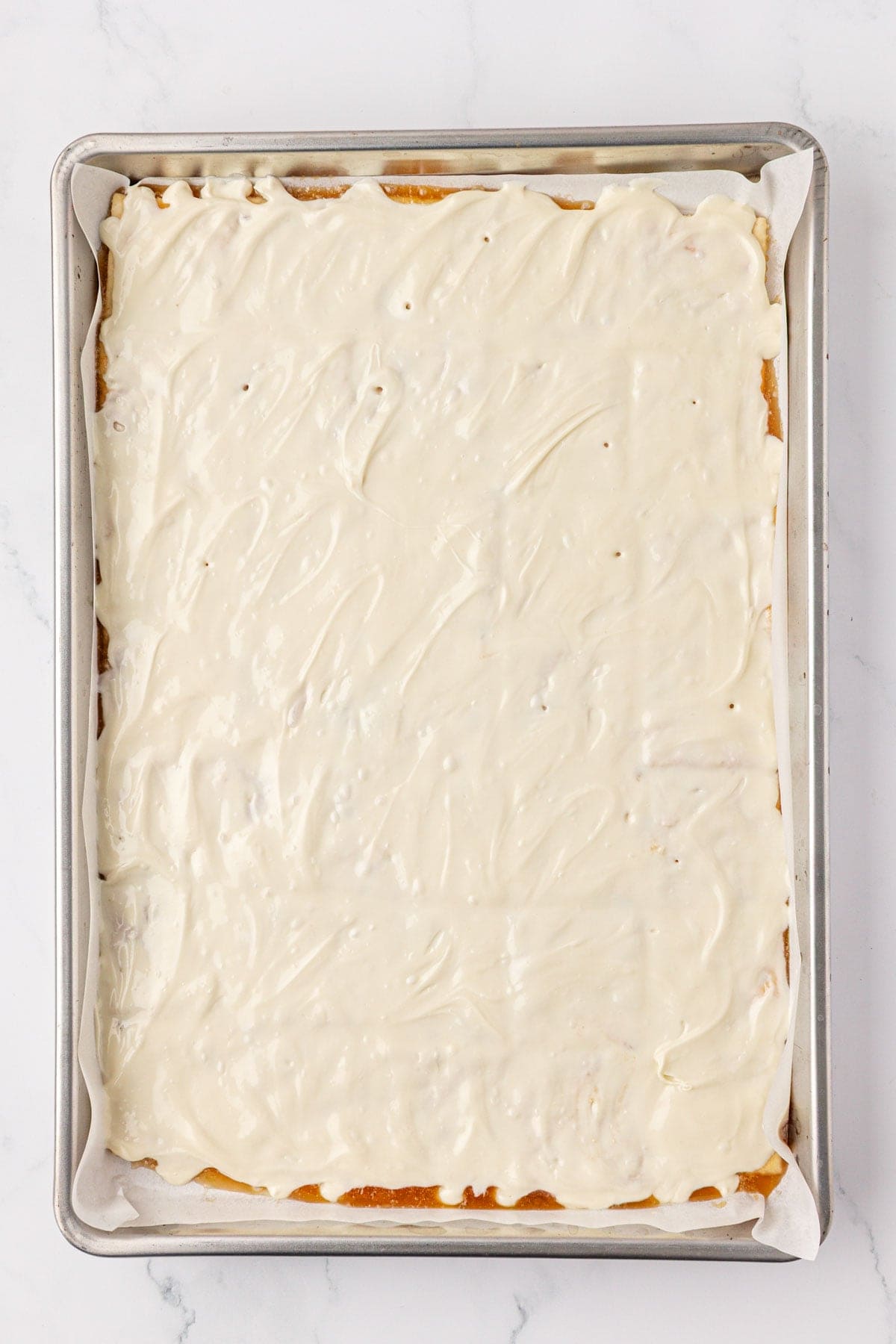 melted white chocolate spread over ritz crackers