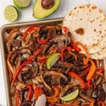 portobello mushroom fajita veggies on a sheet pan with flour tortillas