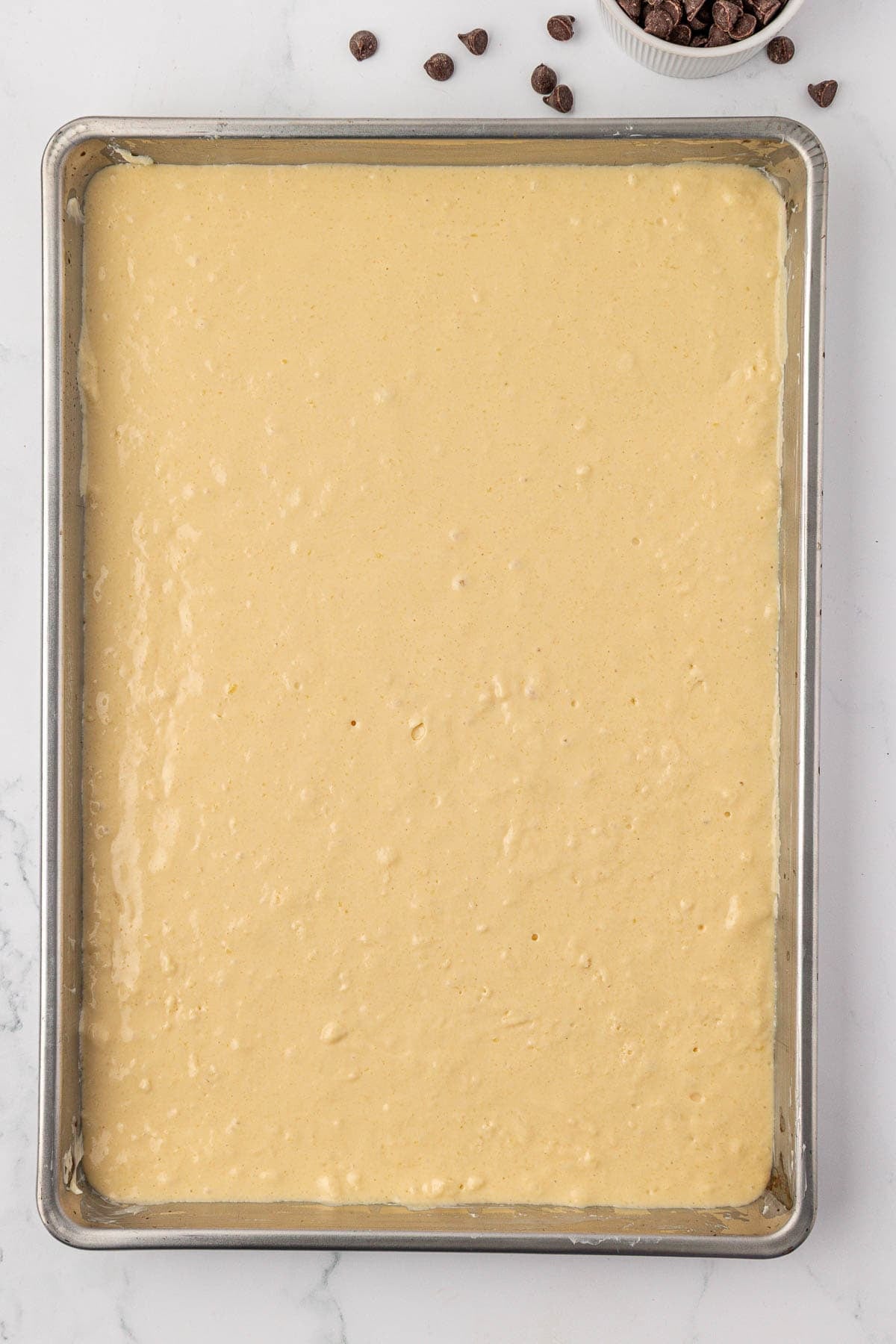 batter spread out on a sheet pan