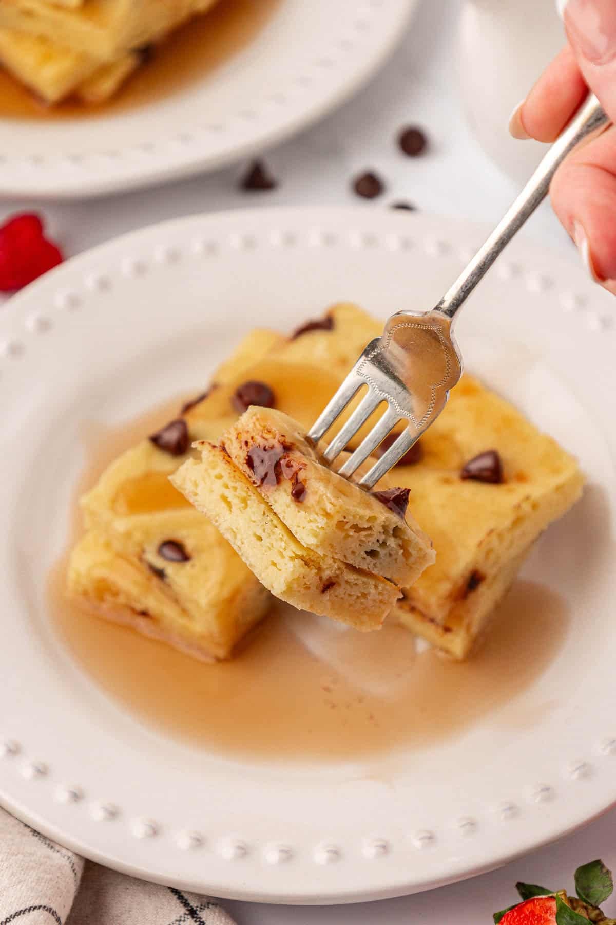 a fork taking a bite of pancakes