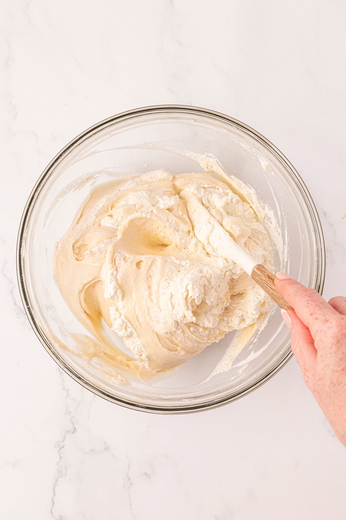 mixing the whipped cream into the cream cheese filling
