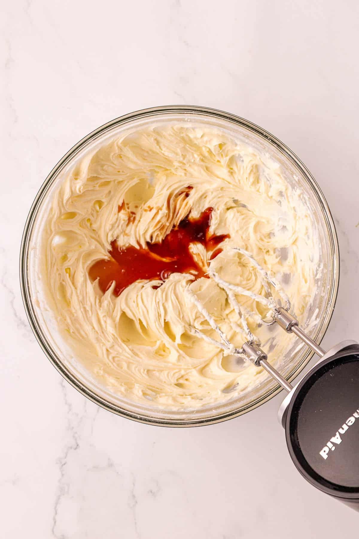 adding vanilla extract to the whipped cream cheese
