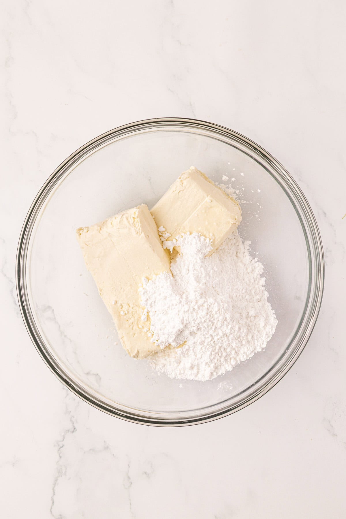 cream cheese and powdered sugar in a mixing bowl