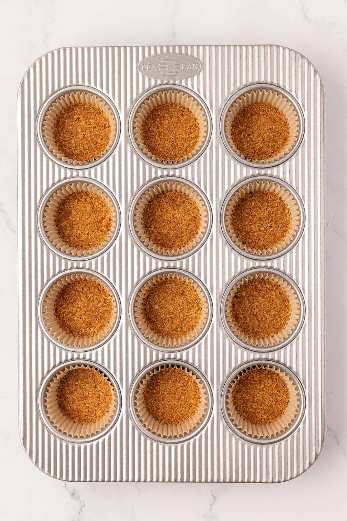graham cracker crusts pressed into a muffin tin