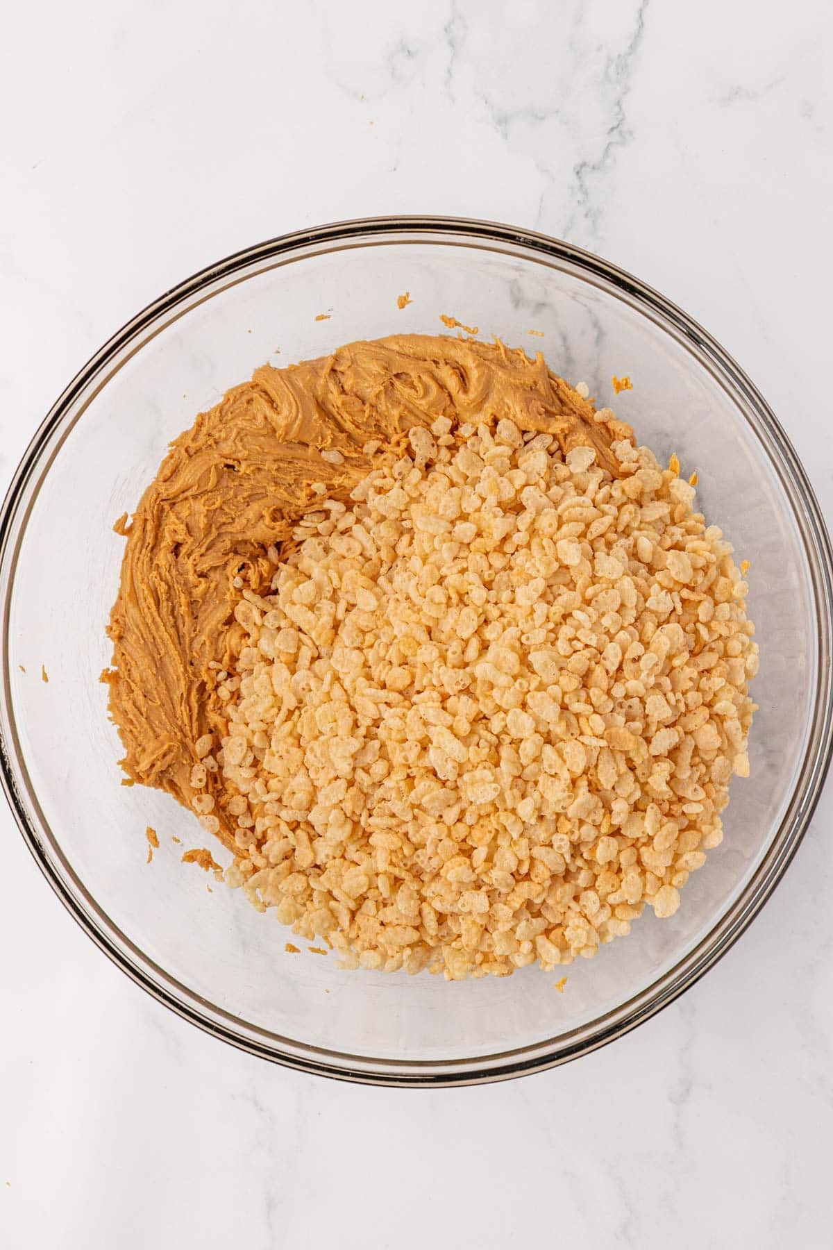 adding the rice krispies to the peanut butter mixture