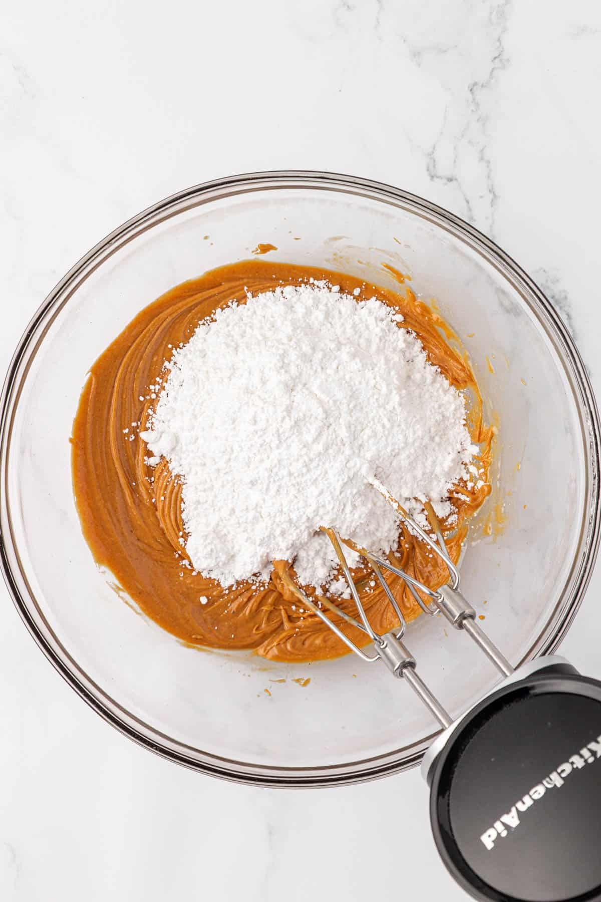 adding the powdered sugar to the peanut butter mixture