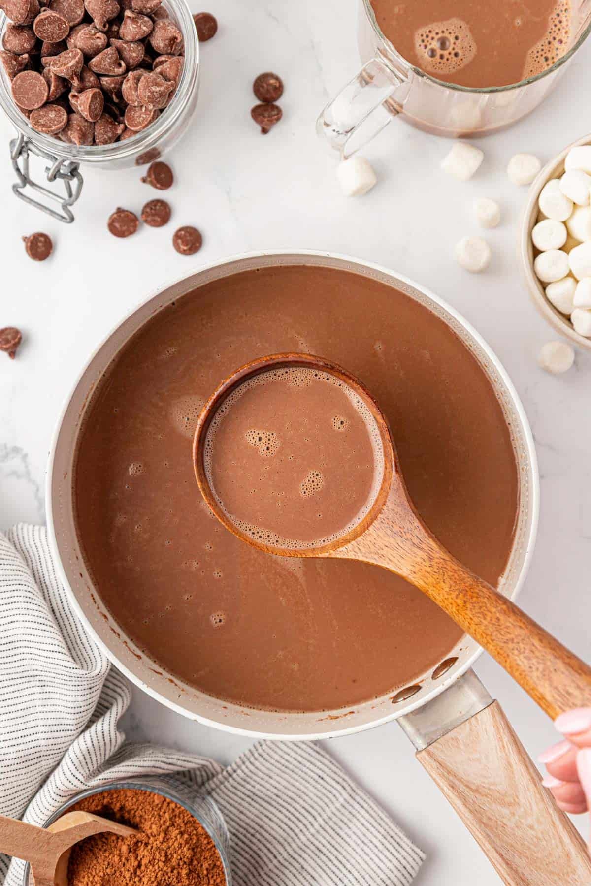 a ladle with hot chocolate over a pot