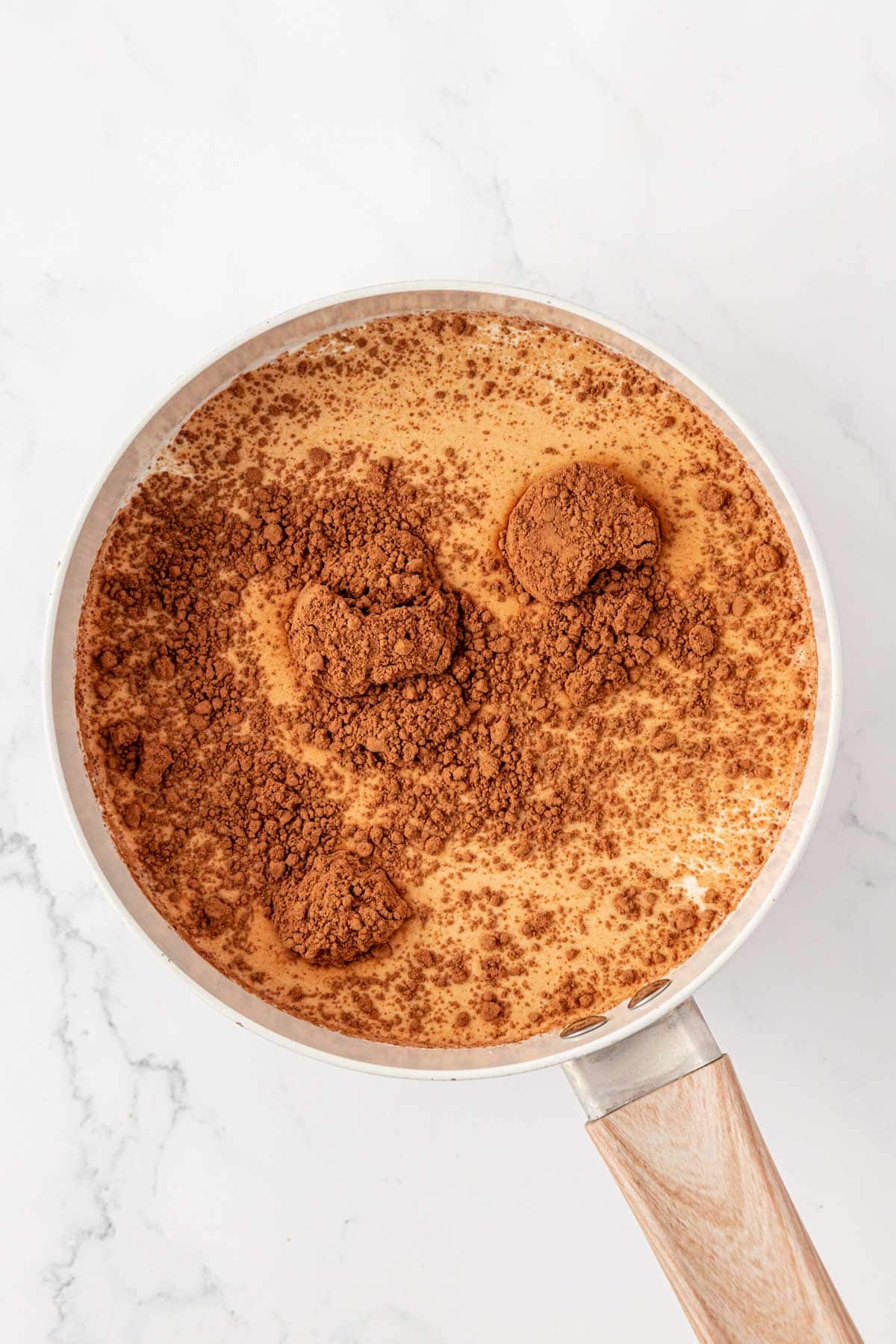 milk, heavy cream, and cocoa powder in a sauce pan