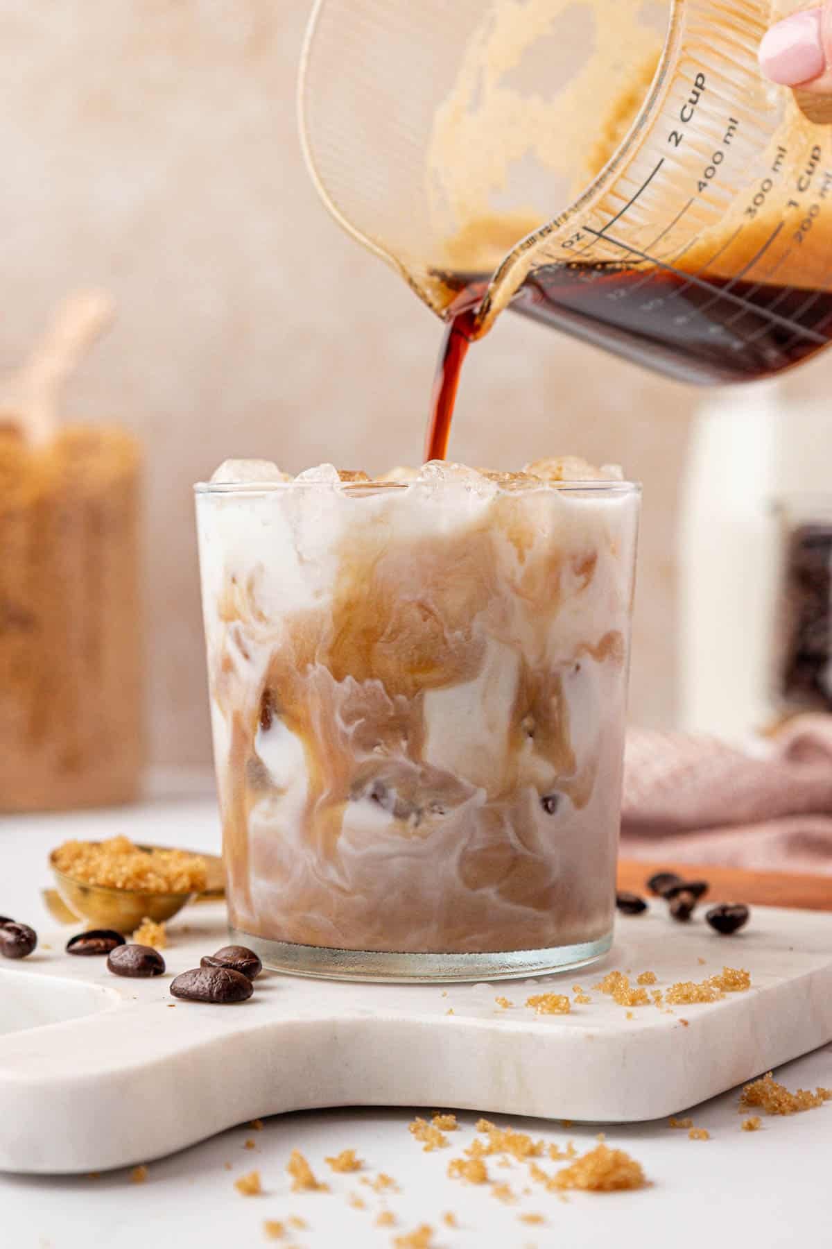 pouring espresso over milk