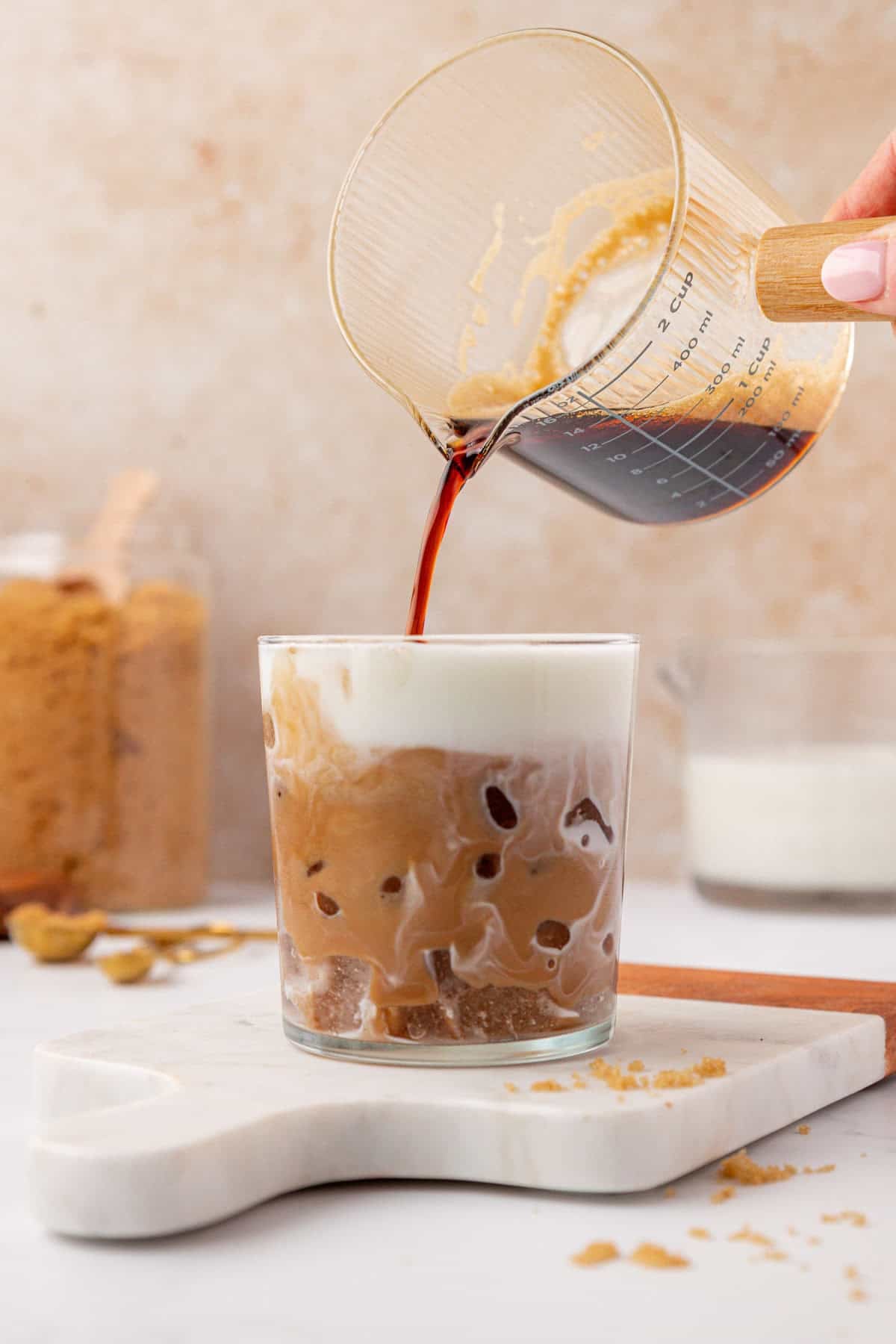 pouring espresso over milk