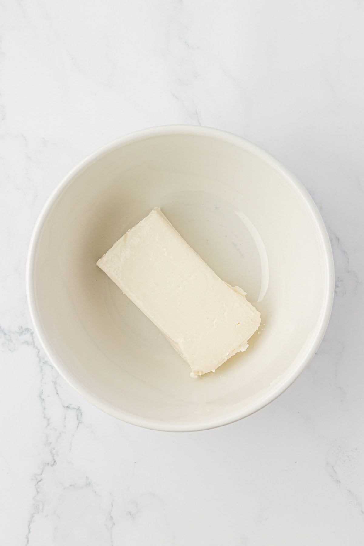 cream cheese block in a mixing bowl