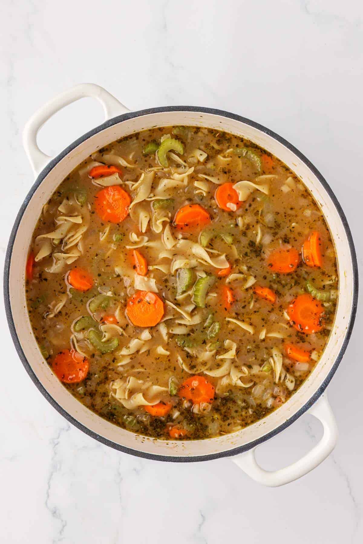 a pot full of vegetable noodle soup