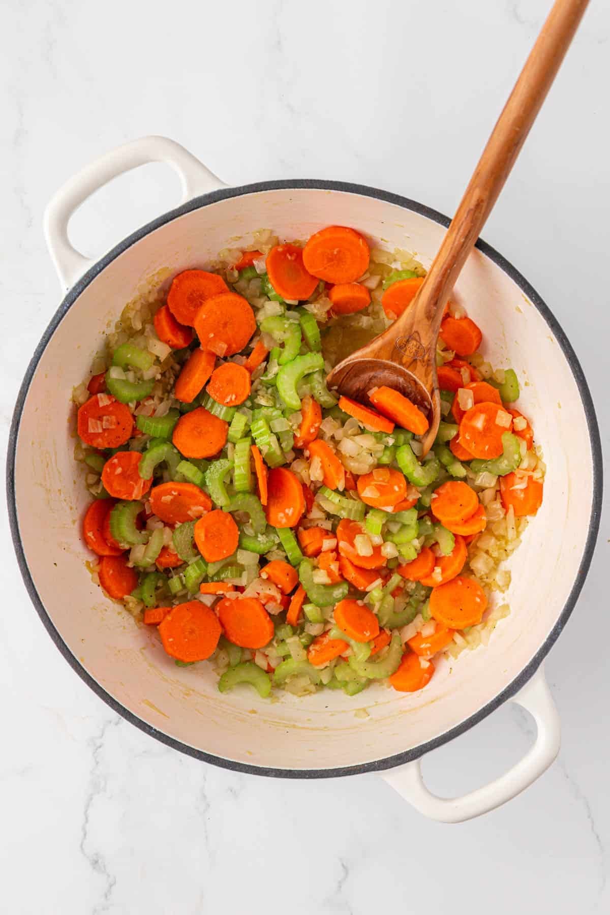 stirring the vegetables while the cook