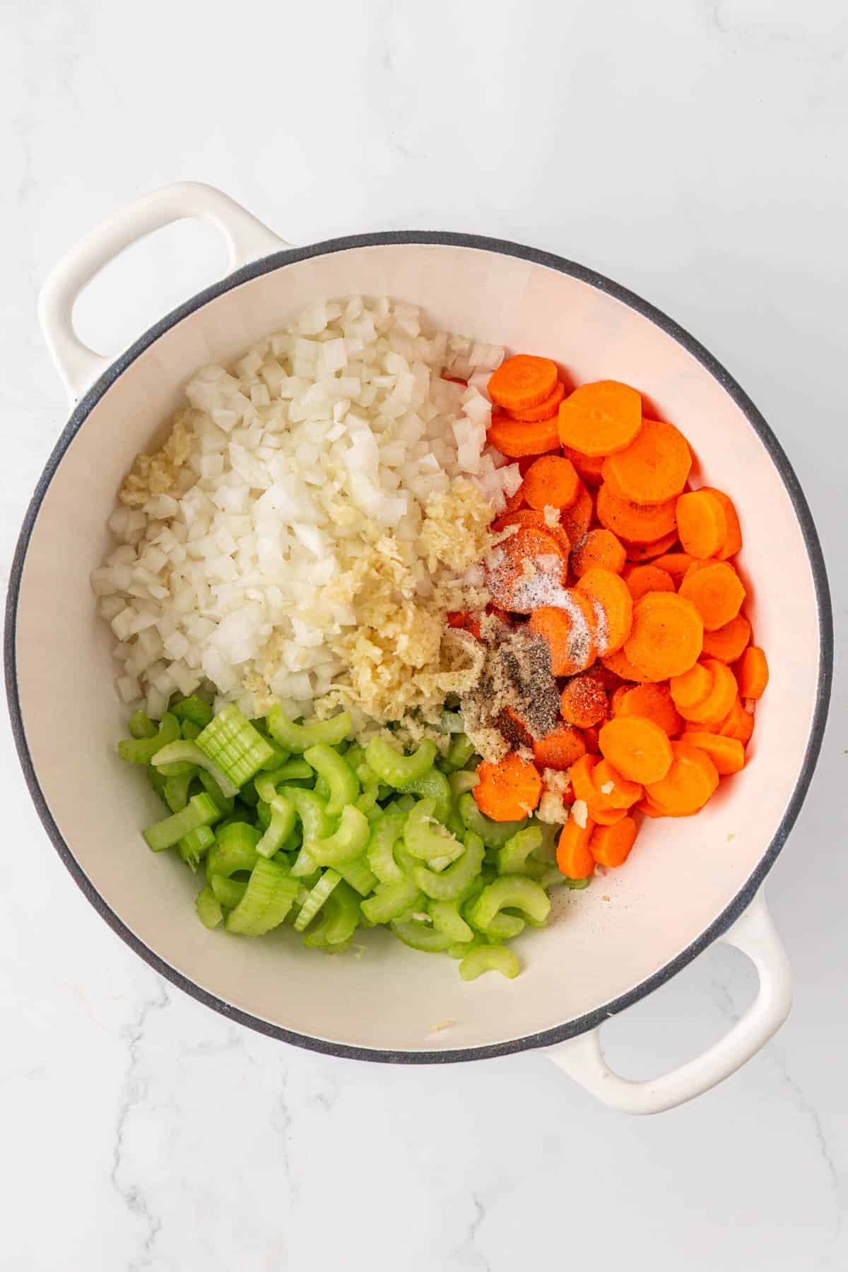 garlic, onion, carrots, celery, and spices in a pot