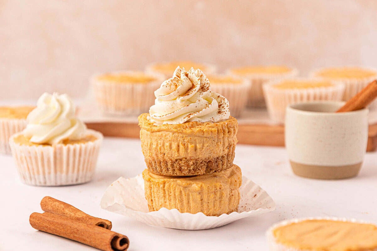 no bake mini pumpkin cheesecakes topped with whipped cream