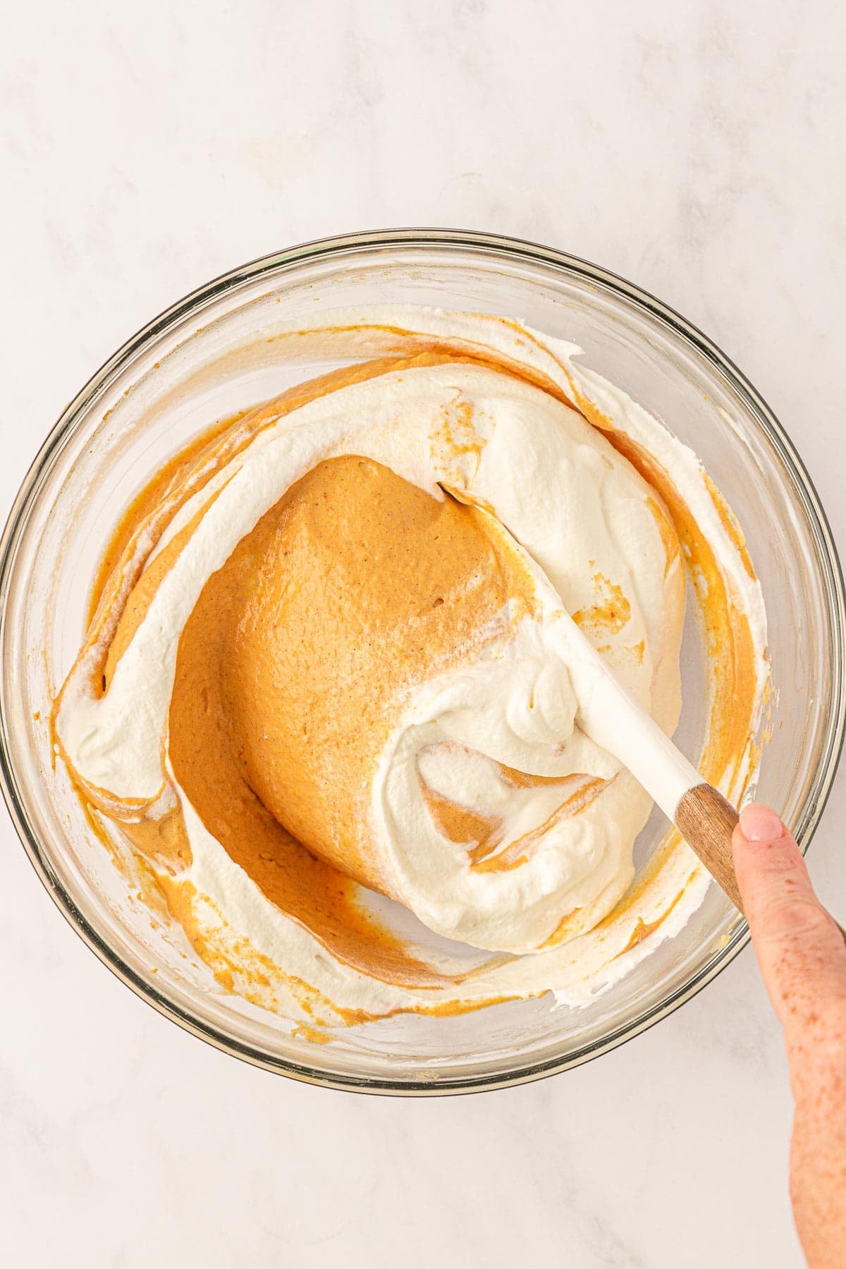 folding the whipped cream into the pumpkin mixture