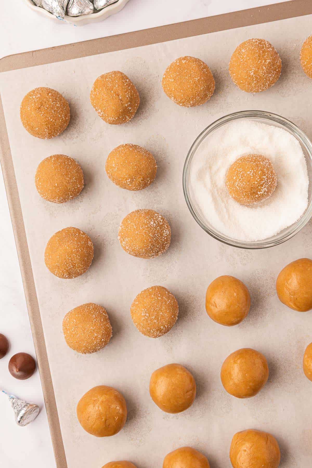rolling the peanut butter cookie balls in sugar
