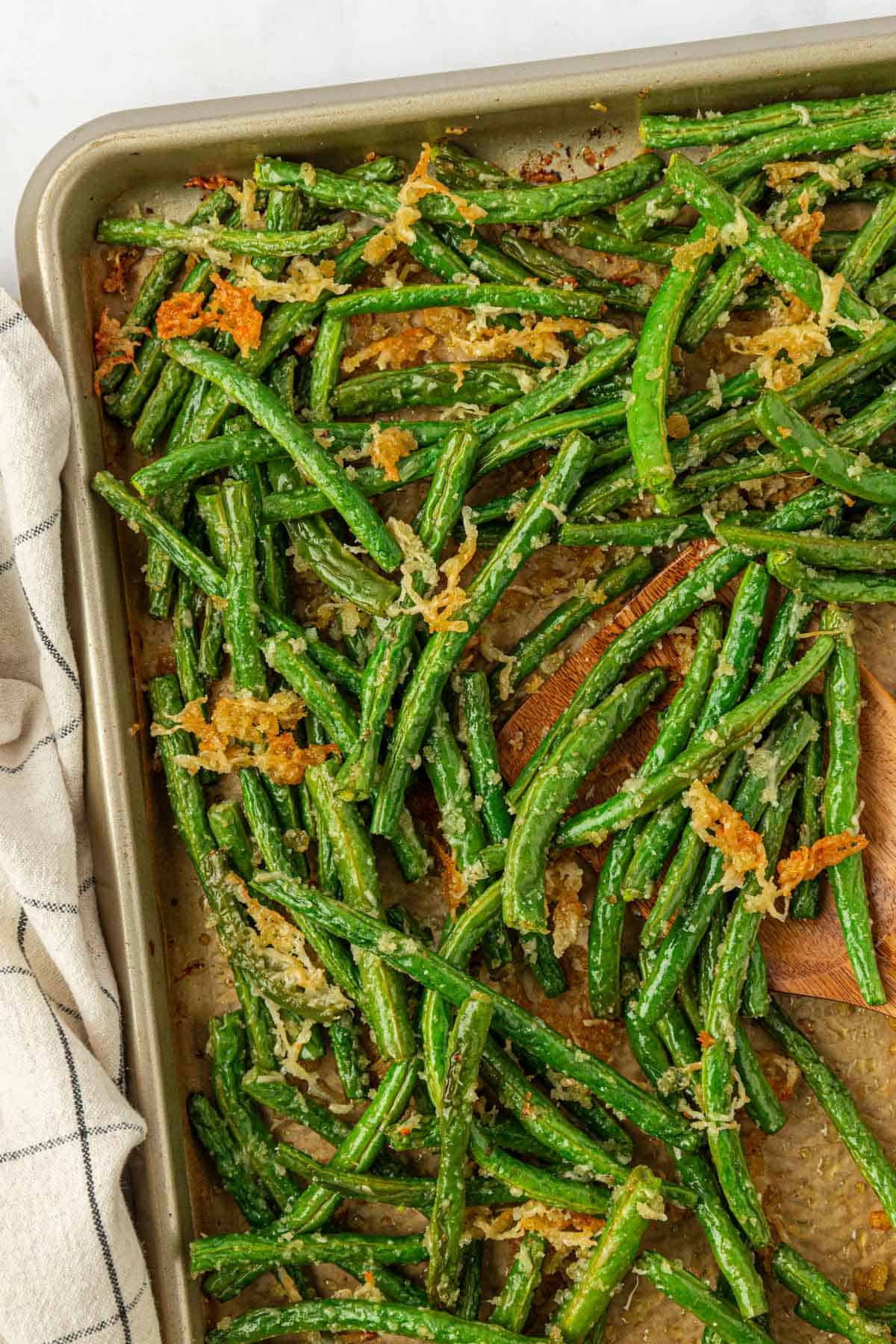 roasted parmesan green beans on a baking sheet