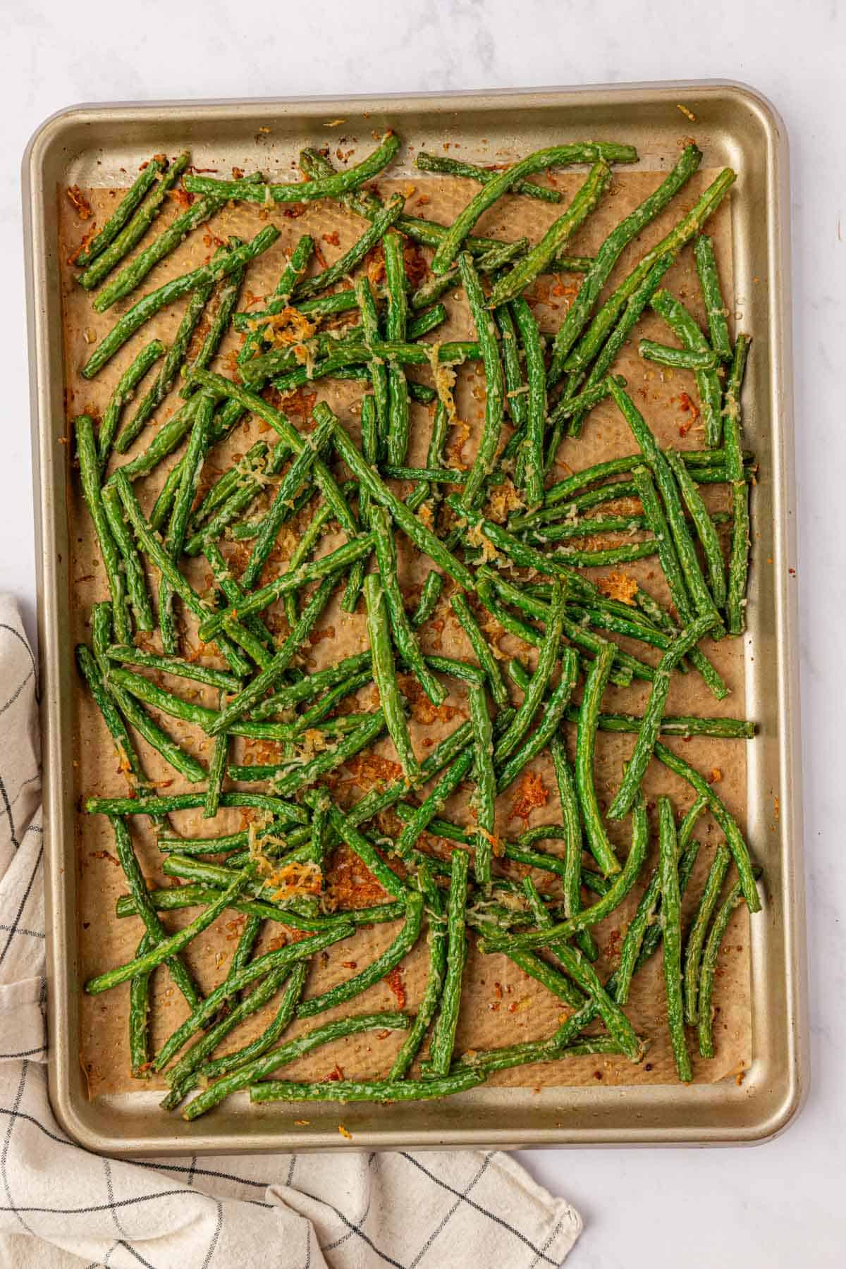 roasted parmesan green beans on a baking sheet