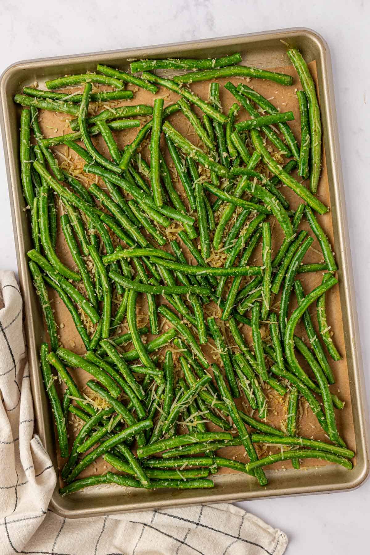 roasted parmesan green beans on a baking sheet